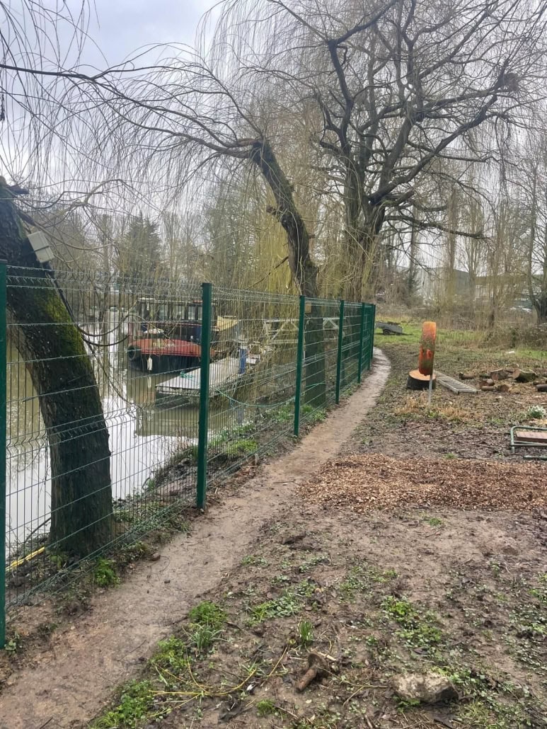 Precision bolt-fixed weldmesh fencing on an existing waterside wall in Bristol