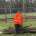 Knight Fencing team member working in waterlogged, muddy ground conditions during a winter timber fencing installation