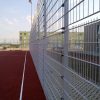 A photo of a fence around a ball court