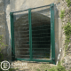 Green mesh security gate installation for an arched tunnel entrance by Knight Fencing.