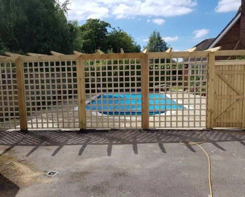 Trellis fence pannel next to a swimming pool