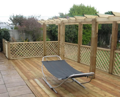 Trellis fence panels surrounding a wooden deck
