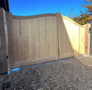 Solid Wooden Garden Gate for Privacy Close-up of a bespoke Dell Quay wooden gate showing the elegant swan neck curved top design and high-quality timber finish