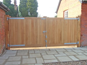 boxgrove-gate-internal-view-heavy-duty-hinges Internal view of Boxgrove wooden gates on a stone patio, showing heavy-duty galvanized strap hinges and robust frame construction