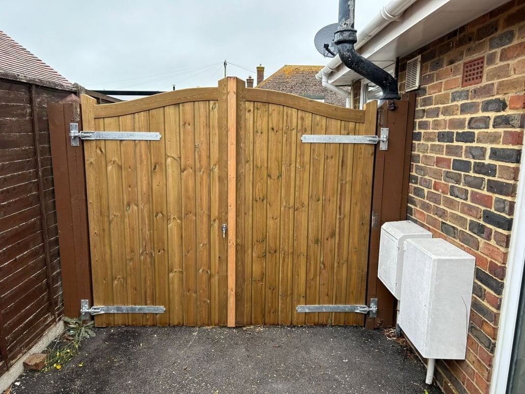 Wooden Garden Gate with Metal Hinges Rear view of a stained Dell Quay gate installation, featuring heavy-duty galvanized hinges and secure locking hardware